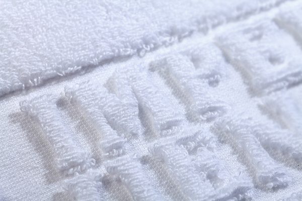 Handtuch Hoch Tief Relief Einwebung terry towel inweaving cotton Baumwolle Detail Buchstaben Hotel Imperial weiss